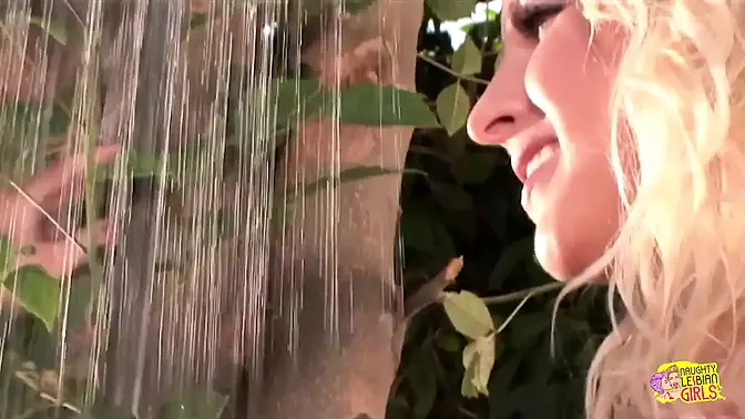 Two gorgeous blondes kiss and finger each other's cunt in the yard