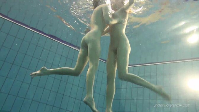 Two hot lesbian babes enjoy a swim in the pool