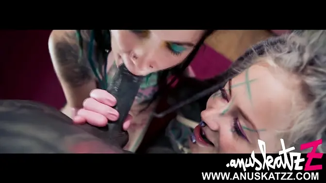 Two tattooed women with dreadlocks give wild blowjob to skinny guy