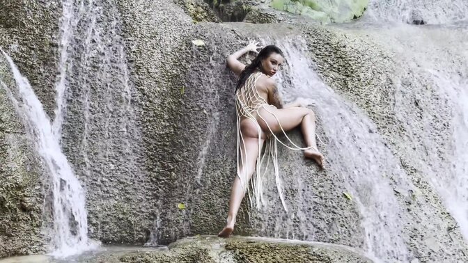 Wet and sexy Russian MILF Monika Fox in a fishnet at the waterfall