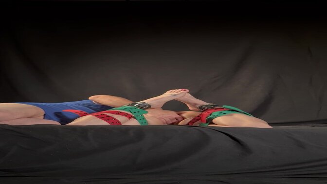 Young and curvy woman bound by holiday-themed belt, waiting to be bred